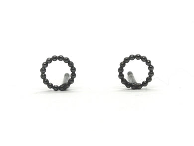 Circle earrings in oxidized silver between