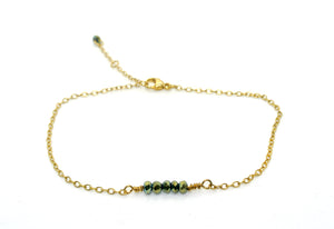 Simple gold-plated bracelet with dark green pearls